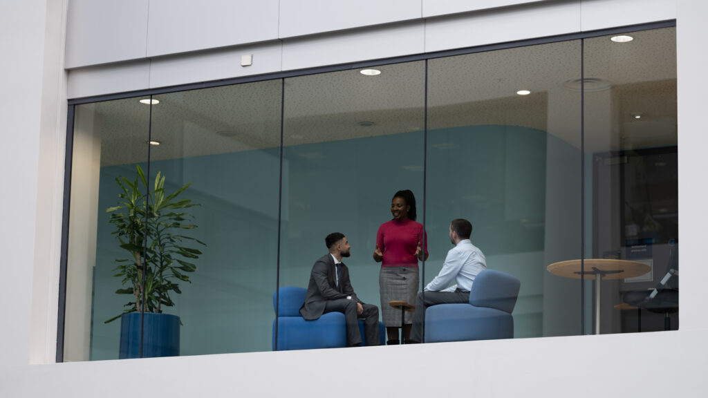 Three members of Home Office staff talking - seen from a distance