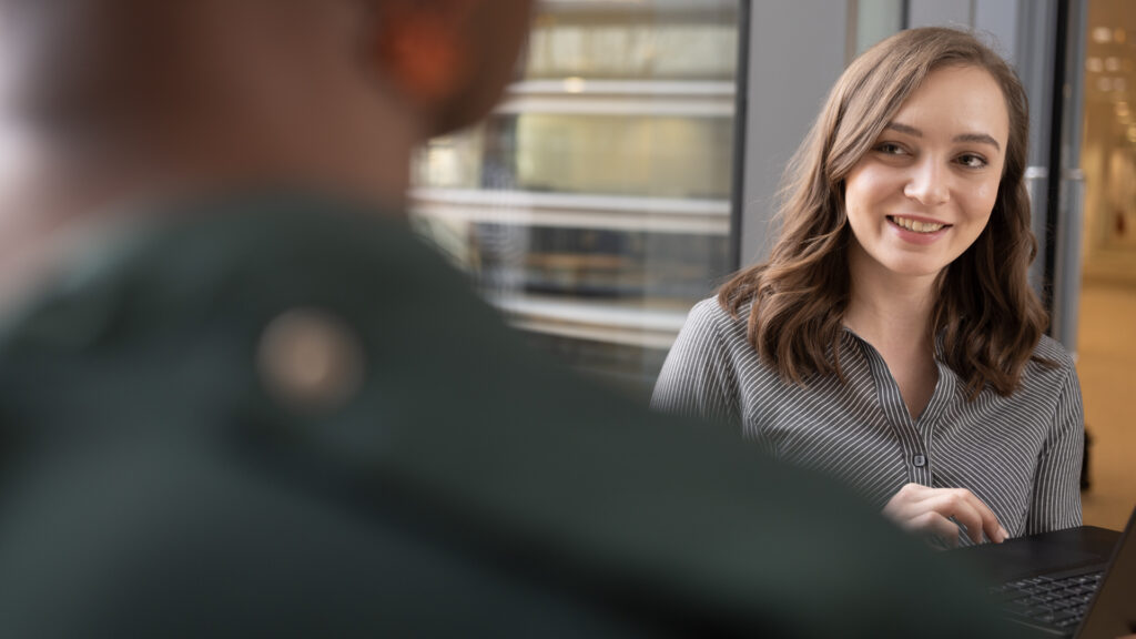 Image of 2 Home Office staff members talking